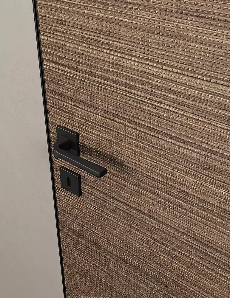 UNIFLEX–3D, Alu, Bolla model, natural veneer Noce Canaletto. Hidden door frame, aluminum edge and handle in Black color. A fragment of the door.