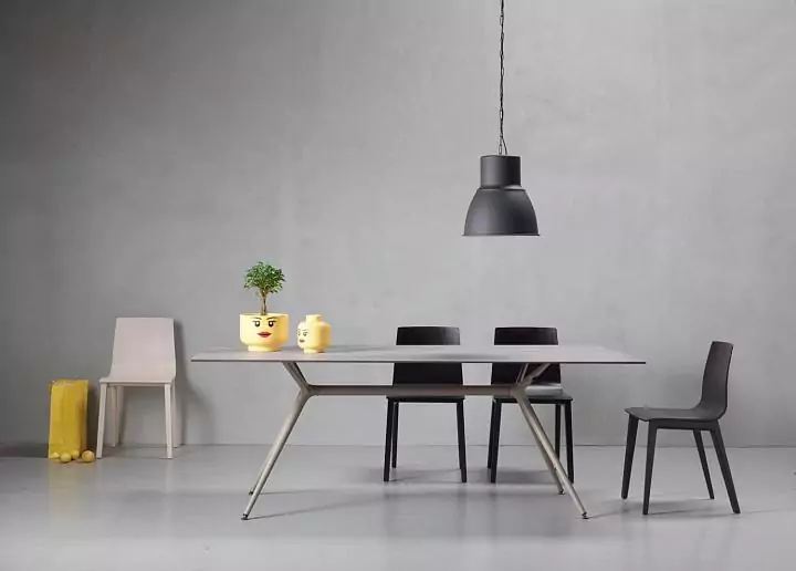 MILAN table. The table top is a universal composite wear–resistant material Marmo Grigio. Base: aluminum, steel–Champagne finish.