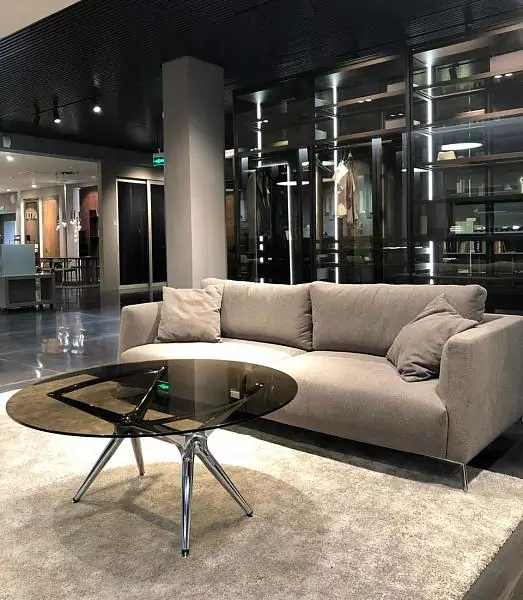 The LOTUS table. Table top–tempered tinted glass Trasparente Bronzo. Base: aluminum, steel–Chrome finish.