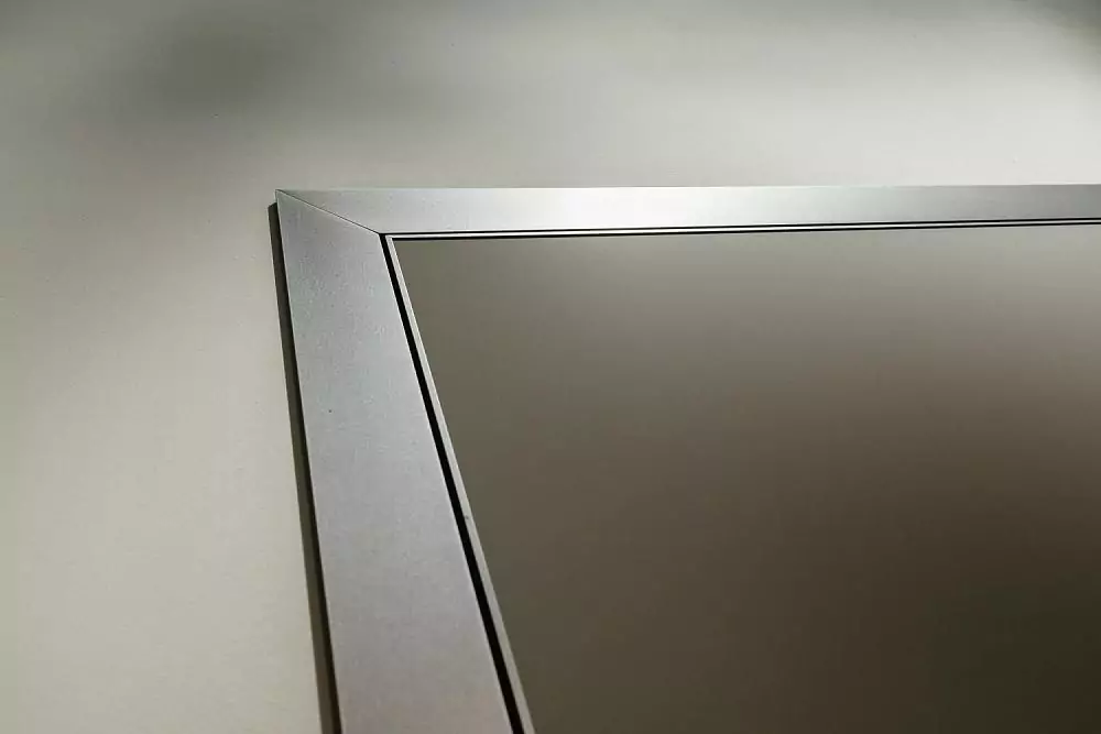 A fragment of a UNIX door. Matt enamel Grigio Seta. Aluminum profile of the canvas and a box with a platband in Piombo color.